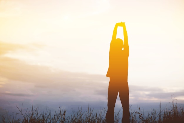 Men, who welcome sunrise with raised hands and enjoying landscape.