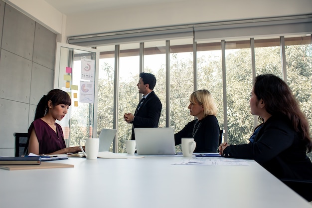 Men with explaining the information in meeting room.