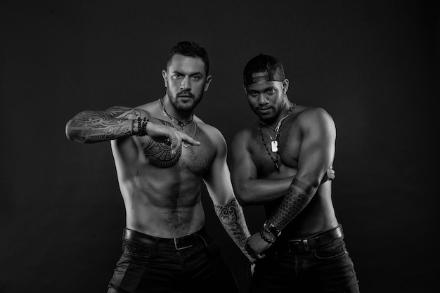 Men with fit tattooed bodies African and hispanic men with sexy bare torsos Fashion models with tattoo in jeans Sportsmen with muscular chest and belly Sport with fitness and bodycare