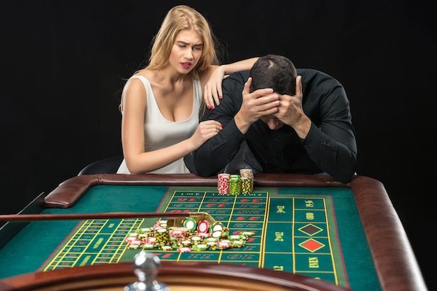 Men with women playing roulette at the casino