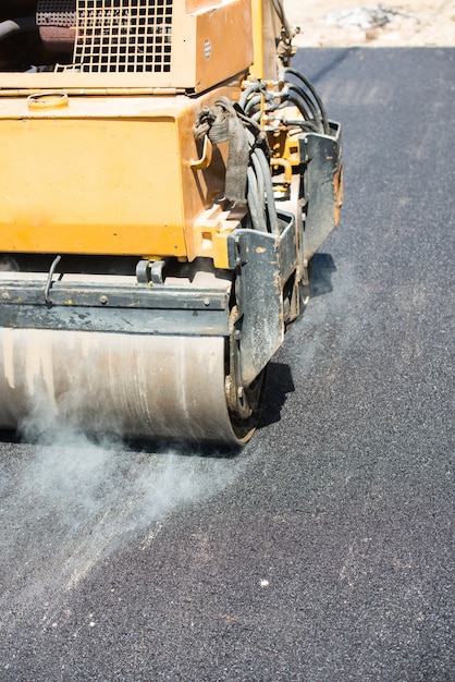 Men working on new street by putting new asphalt 