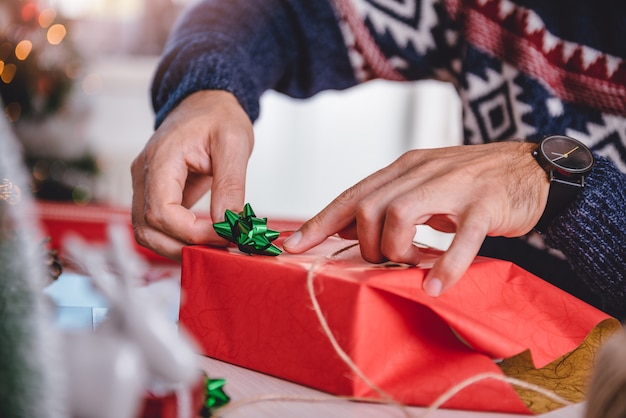 Men wrapping christmas gifts