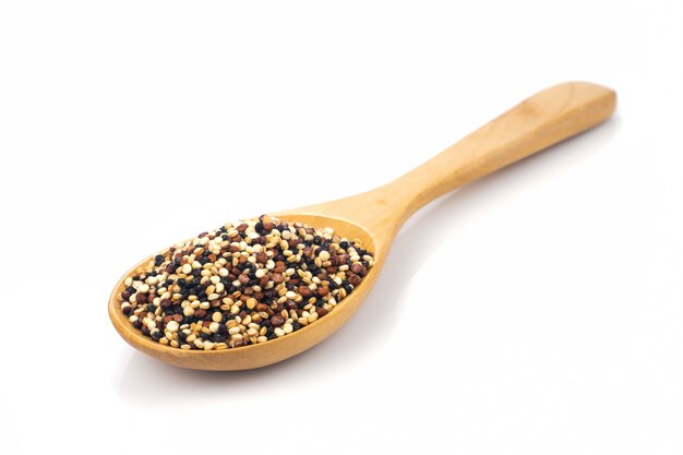 Meng zaden van quinoa-korrels (witte quinoa, zwarte quinoa, rode quinoa) in een houten lepel