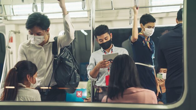 Menigte van mensen die een gezichtsmasker dragen op een drukke openbare metro