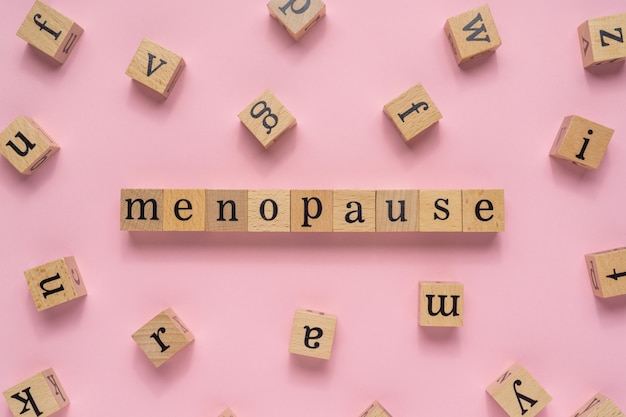 Menopause word on wooden block.