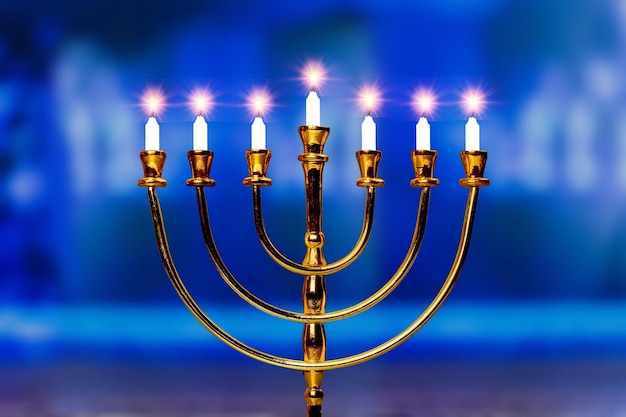 Menorah candelabra lit with burn candles on the last day of Hanukkah Jewish holiday