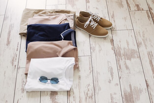 Mens summer basic clothes and shoes on old wooden floor