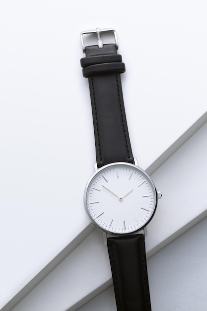 Mens watch with leather strap and white dial isolated on a white background