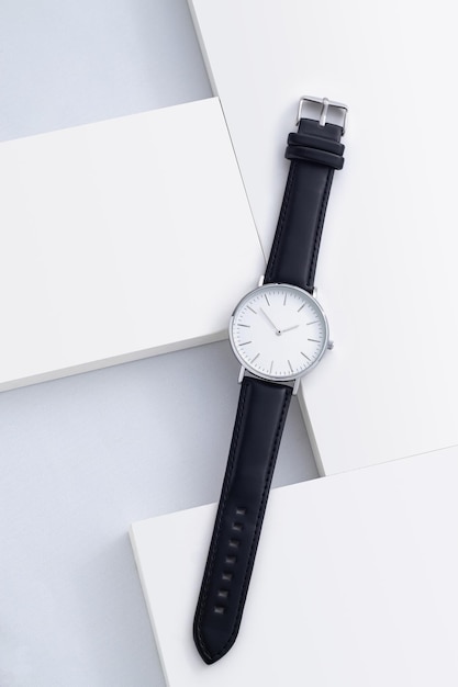 Mens watch with leather strap and white dial isolated on a white background