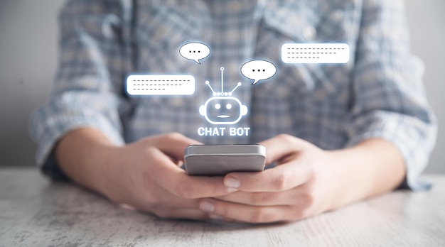 Foto menselijke smartphone met chat bot-applicatie voor online informatie kunstmatige intelligentie concept