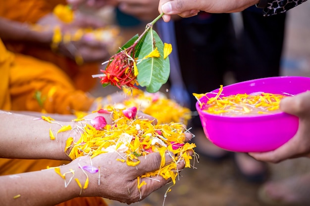 Mensen gieten water naar boeddhistische monniken en geeft zegen in Thailand Songkran jaarlijks festival in boeddhistische tempel