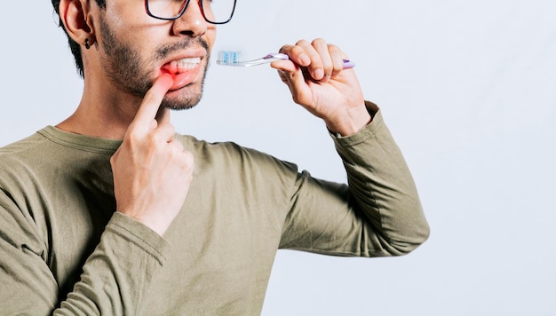 Mensen met tandenborstel met tandvleespijn man met tandenborstel met tandvleespijn mensen met tandenborstel met geïsoleerd tandvleesprobleem jonge man met gingivitis met tandenborstel