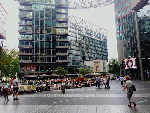 Foto mensen op het stadsplein tegen moderne gebouwen