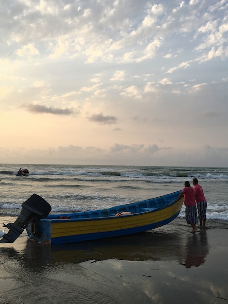 Mensen op zee strand bij zonsondergang met plezier