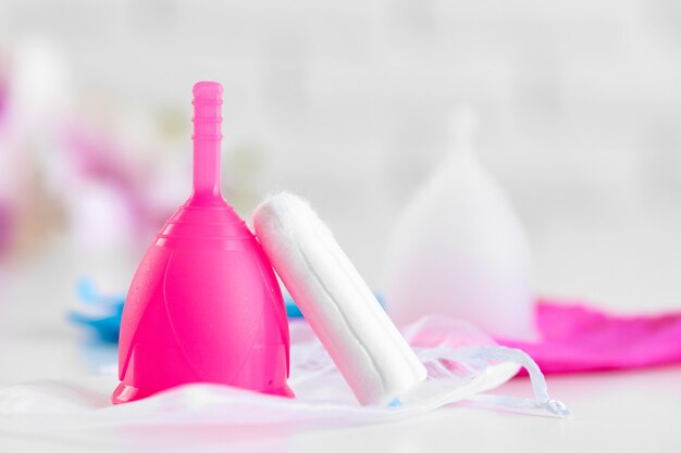 Menstrual cup and medical tampon close up