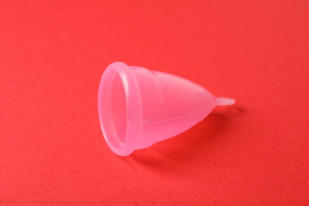 Menstrual cup on red surface