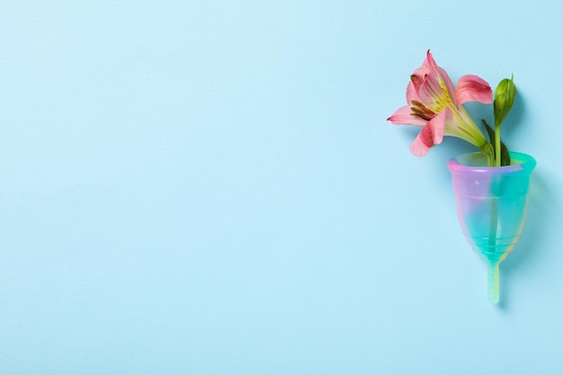 Menstrual cup with a flower on a blue background