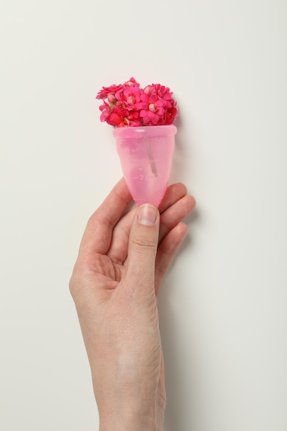 Menstrual cup with flowers inside in hand