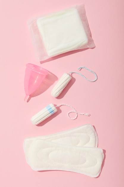 Menstrual feminine hygiene products on a pink background