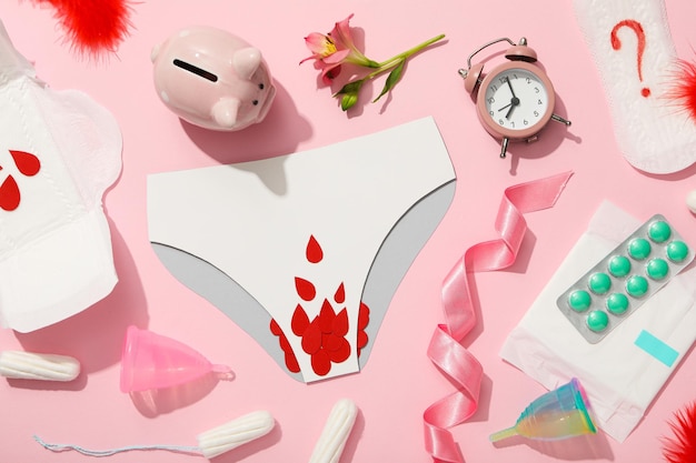 Menstrual feminine hygiene products on a pink background