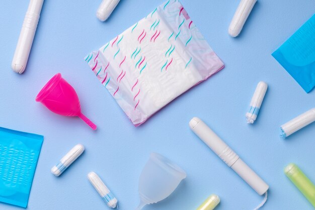 menstrual hygiene products including cup, pads and tampon top view