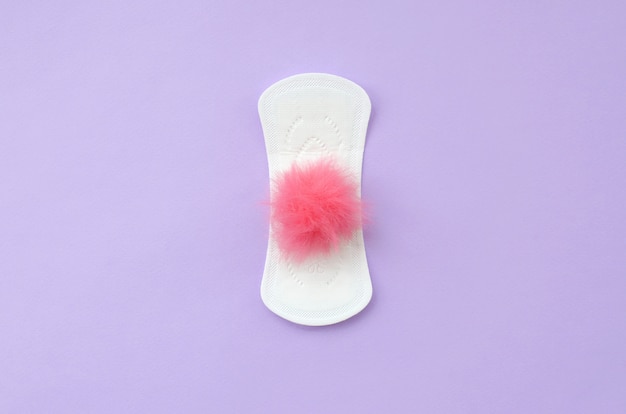 Menstrual pad and red fluffy fuzzy as a blood