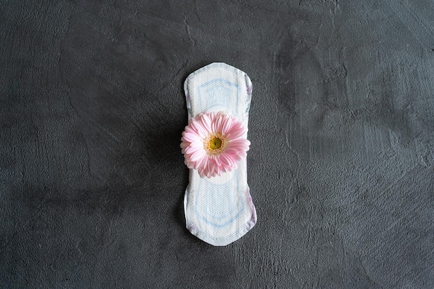 Menstruation period concept Hygienic white female pad with gerbera flowers Menstruation protection Women's health