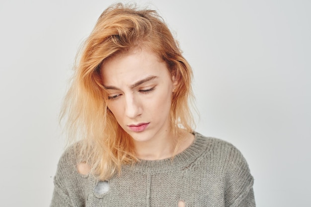 Mental disorder. Sad girl in a depression on a white background.