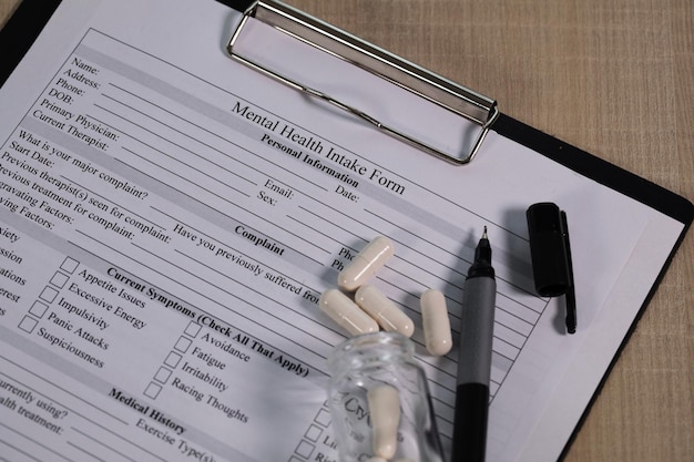 Mental health intake form and a pen on a table. Closeup