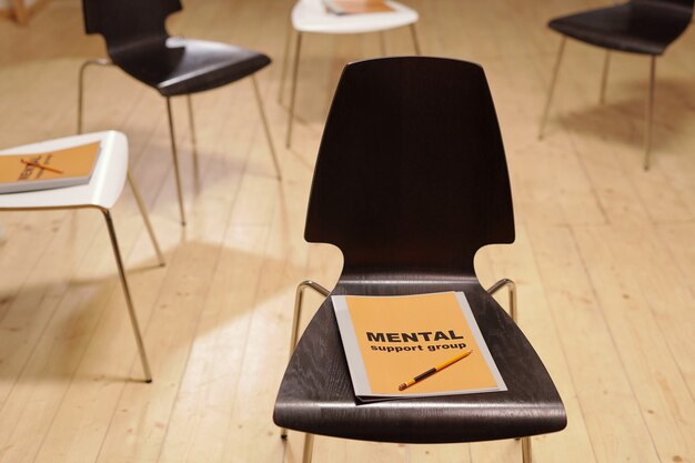 Mental support group journals on group of chairs in classroom