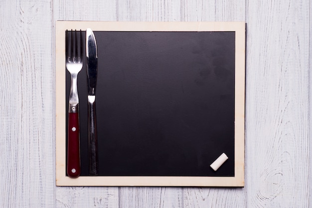 Menu blackboard with knife and fork