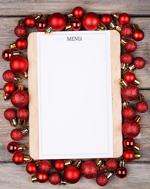 Menu board with Christmas decoration on wooden planks background