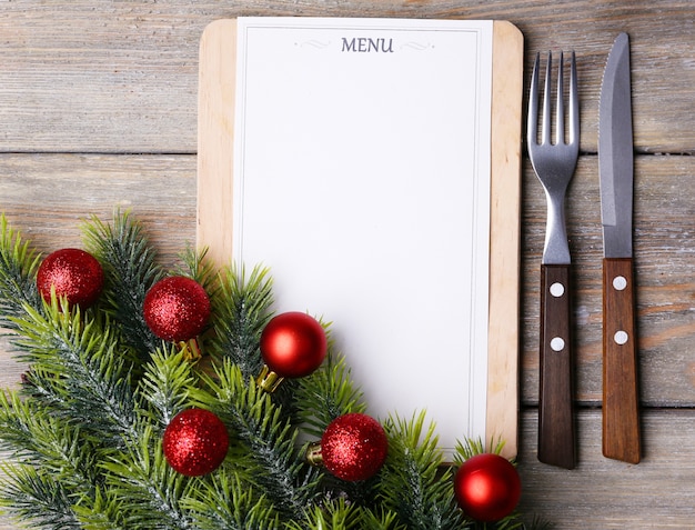 Menu board with Christmas decoration on wooden planks background