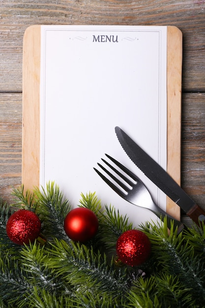 Menu board with Christmas decoration on wooden planks background