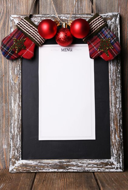 Photo menu board with christmas decoration on wooden planks background