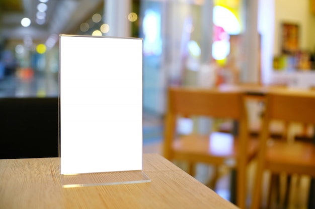 Photo menu frame standing on wood table in bar restaurant cafe