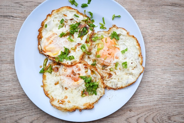 Menu healthy food in the moring healthy breakfast fried eggs on plate with coriander and sauce food fried egg top view