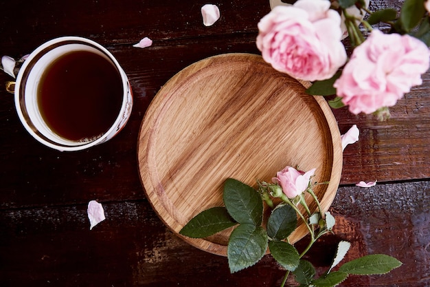 Menu or recipe mockup wooden plate podium Morning aesthetic Invitation wedding Mothers day card mockup among pink tea rose petals Place for text View from above