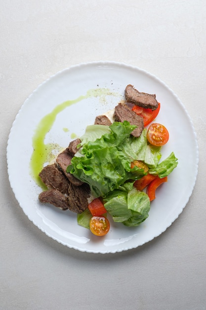 menu for the restaurant salad with beef lettuce and cherry tomatoes and spice dressing