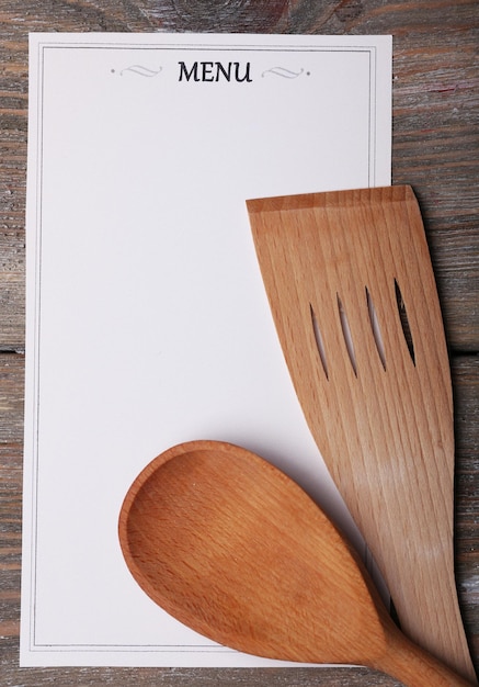 Menu sheet of paper on rustic wooden surface background