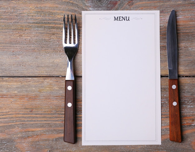 Menu sheet of paper on rustic wooden surface background