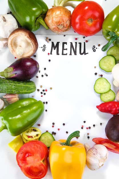 Menu surrounded by products and vegetables isolated on white
