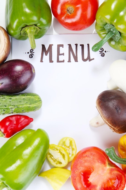 Photo menu surrounded by products and vegetables isolated on white