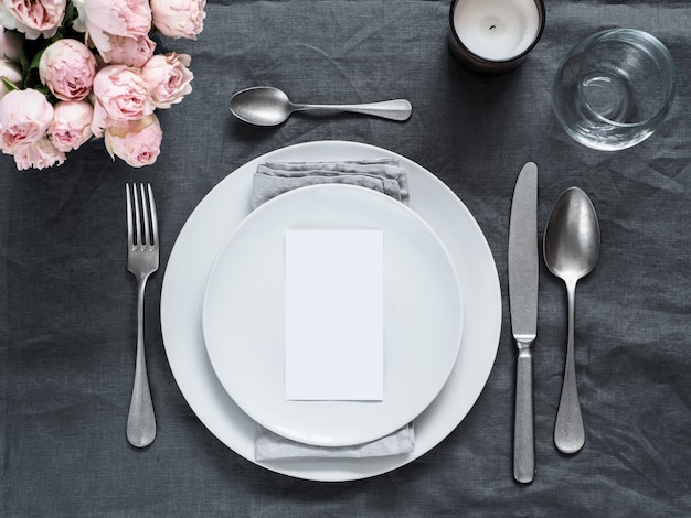 Menu, wedding invitation . Beautiful table setting on gray linen tablecloth. 