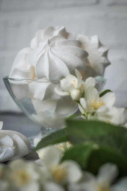 Meringue cake with a jasmine flowers on background