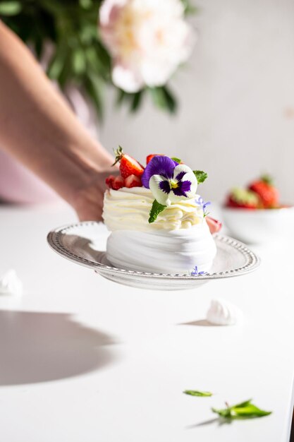 Meringue dessert with berries and flowers for breakfast