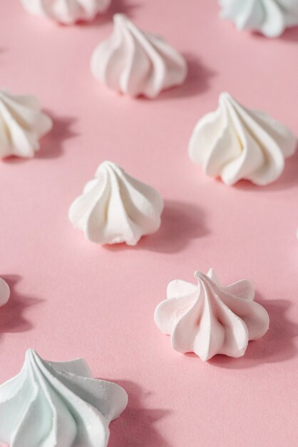 Meringue on pink background