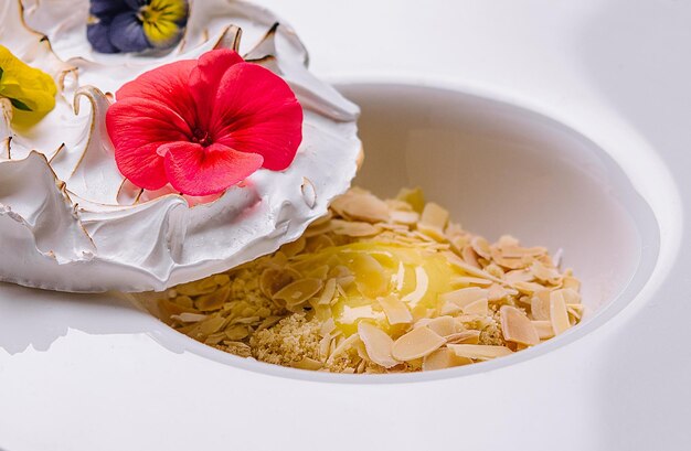 Meringue on plate and almonds with vanilla custard