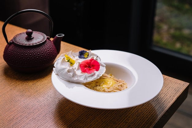 Meringue on plate and almonds with vanilla custard