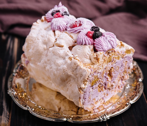 Meringue roll cake with cream and berries